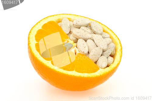 Image of Close up of orange and pills isolated 