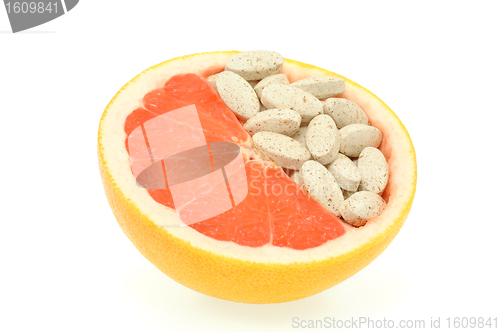 Image of Close up of red grapefruit and pills isolated