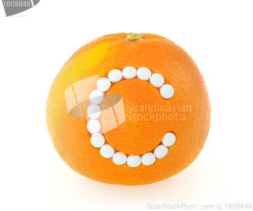 Image of Grapefruit with vitamin c pills over white background