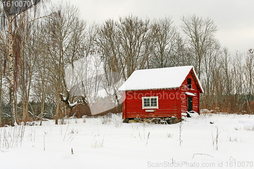 Image of Traditional Swedish red wooden house in snow