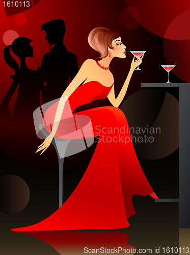 Image of Woman having cocktail at the bar