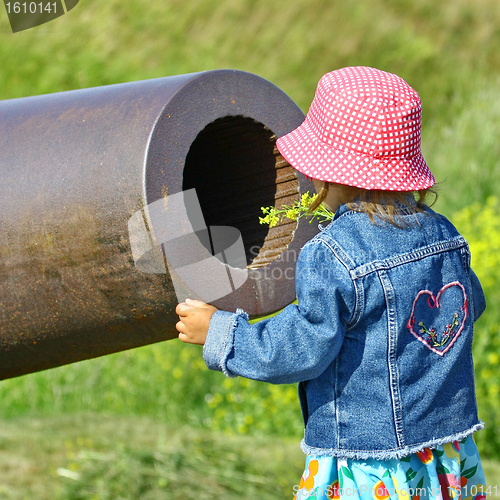 Image of Little girl, gun and yellow flowers