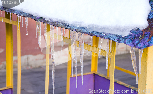 Image of Melting icicles spring on roof playground house. 