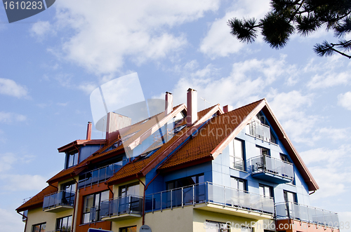 Image of Modernist architecture building sunlit cloudy sky 