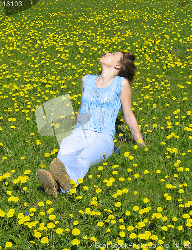 Image of Girl on dandelion lawn