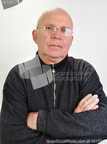 Image of senior man with glasses  and hands crossed on  chest