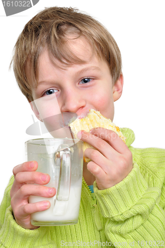 Image of child eating cake and drinking milk