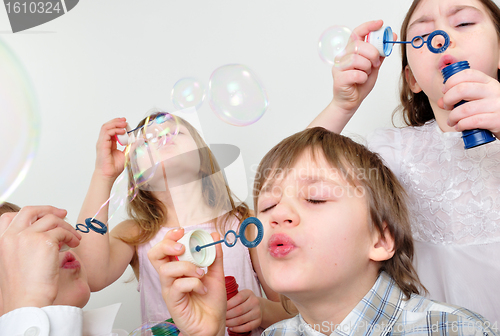 Image of children firends blowing bubbles