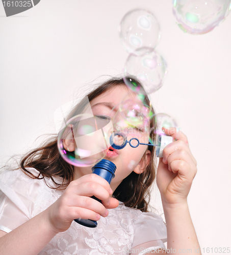 Image of child blowing bubbles with bubble wand