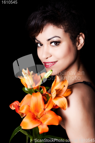 Image of Young Beautiful Woman Holding Lily Flowers