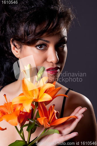 Image of Young Beautiful Woman Holding Lily Flowers