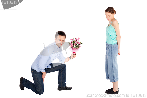 Image of Casual Man Offering Flowers to Woman