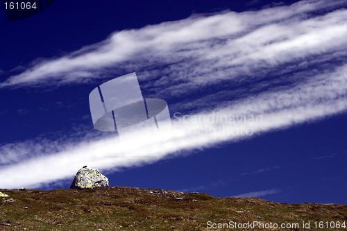 Image of A rock and some clouds.