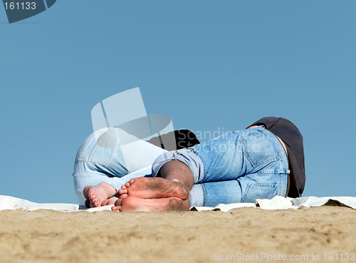 Image of Couple sleeping on the beach