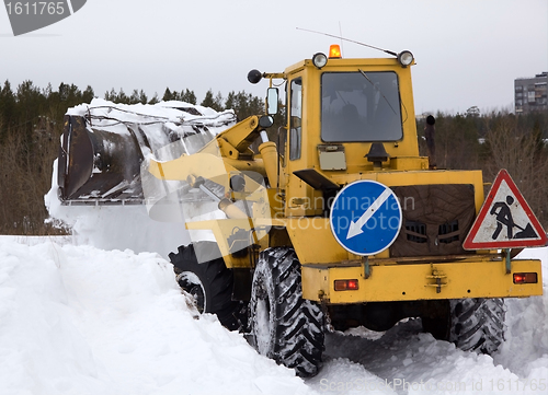 Image of The tractor clears snow from the road blockage