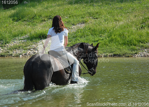 Image of riding woman in river