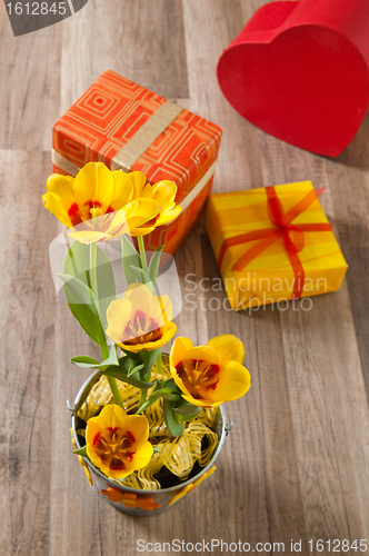 Image of It is red yellow tulips and gift boxes, a close up