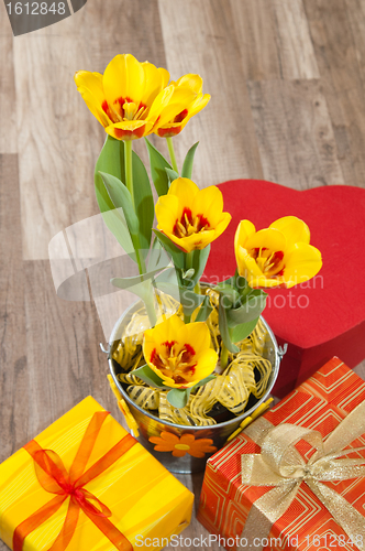 Image of It is red yellow tulips and gift boxes, a close up