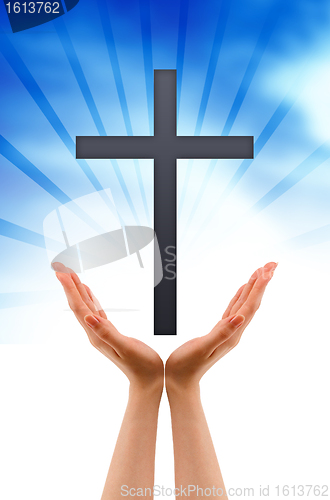 Image of Hand holding a Cross