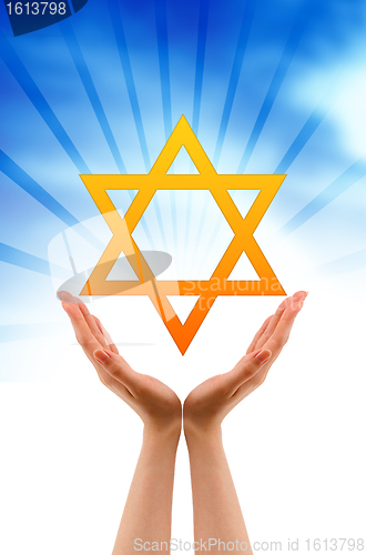 Image of Hand holding a Jewish Star 