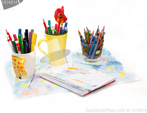 Image of Abstract painting  and pen holders  with colored pens