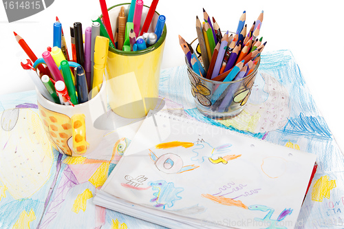 Image of Abstract painting  and pen holders  with colored pens