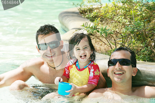 Image of Happy family having fun in swimming pool.  Brothers and niece ha