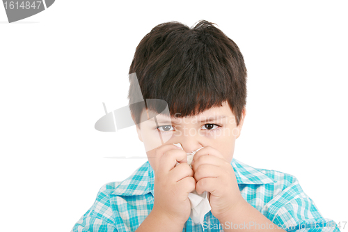 Image of Human child cold flu illness tissue blowing nose 