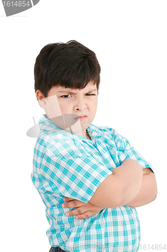 Image of serious little boy with hands folded standing isolated on white 