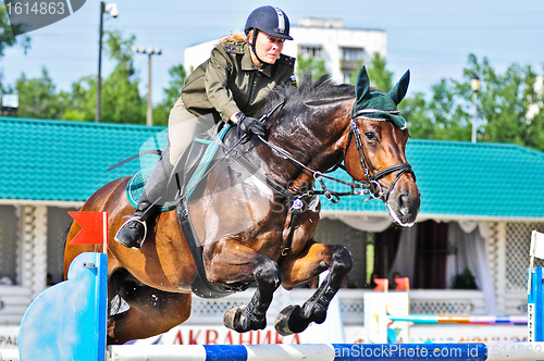 Image of Female rider on jump horse