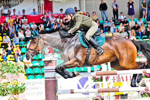 Image of Female rider on jump horse