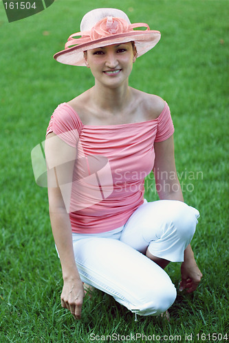 Image of Woman in a pink straw hat