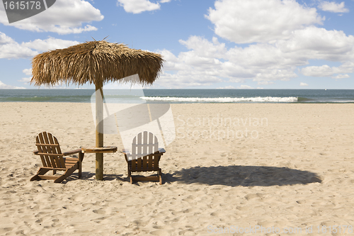 Image of Two Beach Chairs and Umbrella on Beautiful Ocean Sand