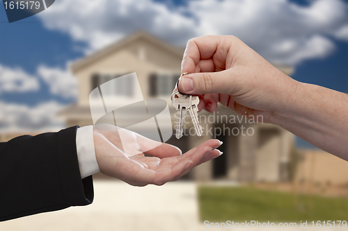 Image of Handing Over the House Keys in Front of New Home