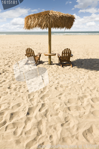 Image of Two Beach Chairs and Umbrella on Beautiful Ocean Sand