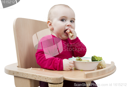 Image of young child eating in high chair