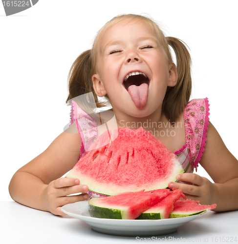 Image of Cute little girl is gungy to eat watermelon