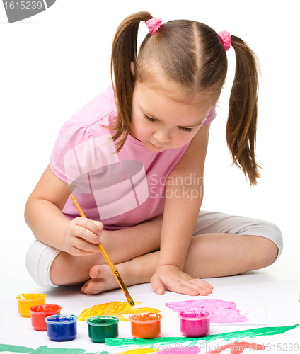 Image of Cute cheerful child play with paints
