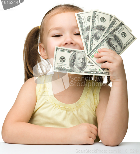 Image of Cute little girl with paper money - dollars