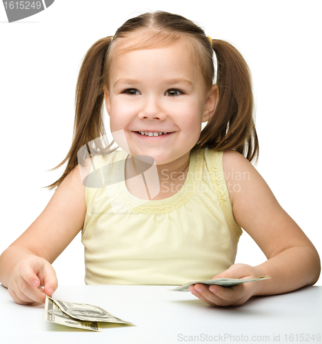 Image of Cute little girl with paper money - dollars