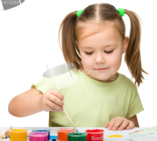 Image of Cute cheerful child play with paints