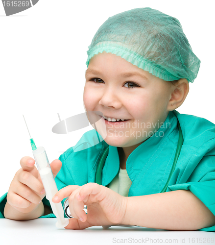 Image of Cute little girl is playing doctor with syringe