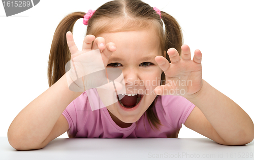Image of Cute little girl is showing a tiger