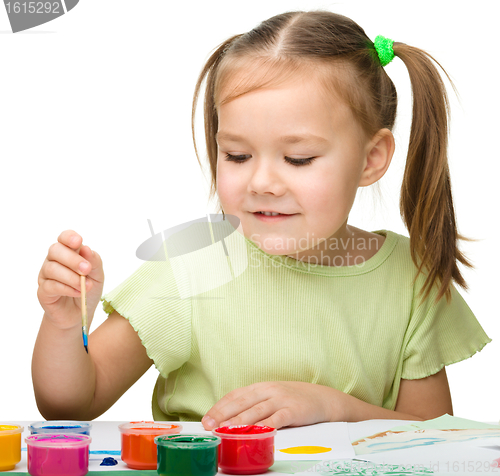 Image of Cute cheerful child play with paints