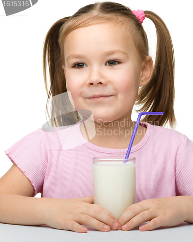 Image of Cute little girl with a glass of milk