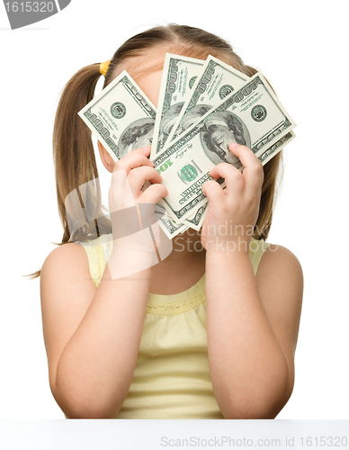 Image of Cute little girl with dollars