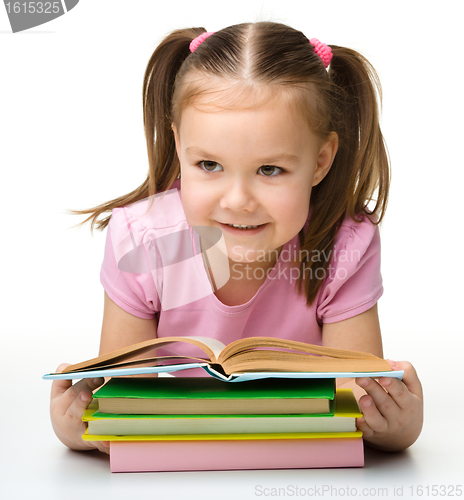 Image of Cute little girl reads a book