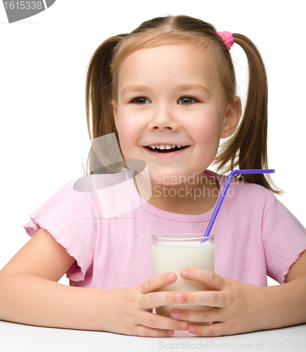 Image of Cute little girl with a glass of milk