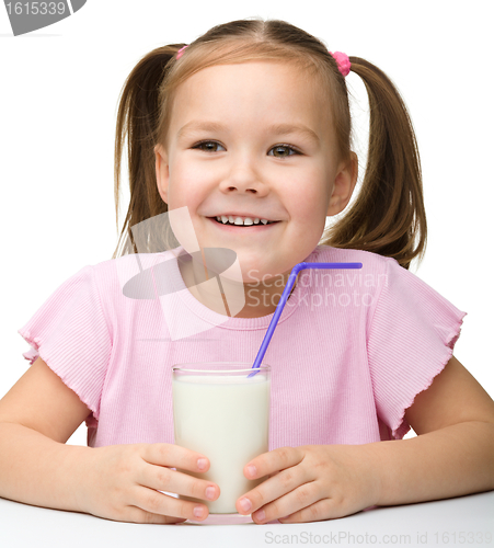 Image of Cute little girl with a glass of milk