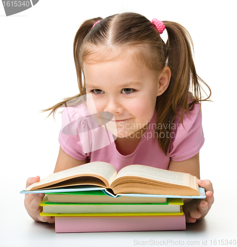 Image of Cute little girl reads a book